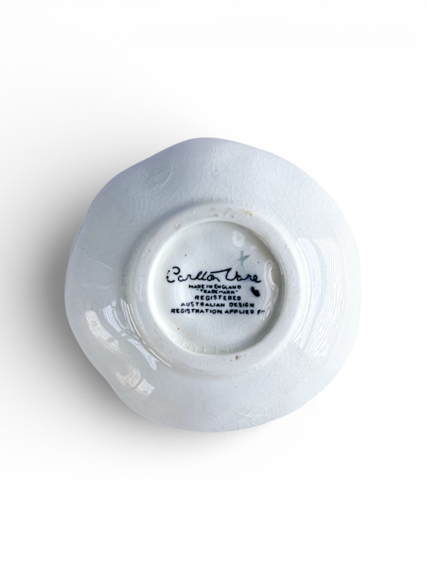Bottom view of a white porcelain plate with Carlton Ware English mark and Australian design registration