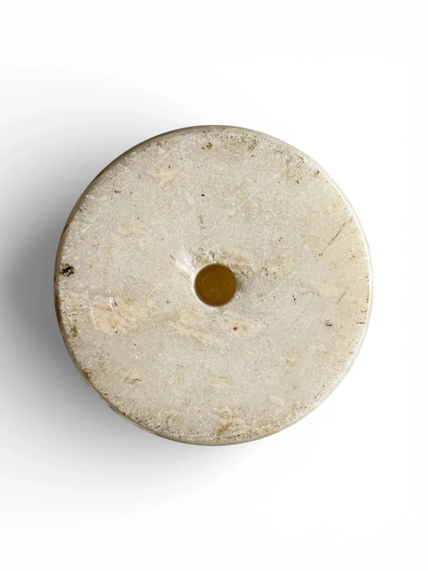 Underside of an Italian alabaster vase featuring the original lathe centre mark, confirming the piece is hand-turned from solid stone.