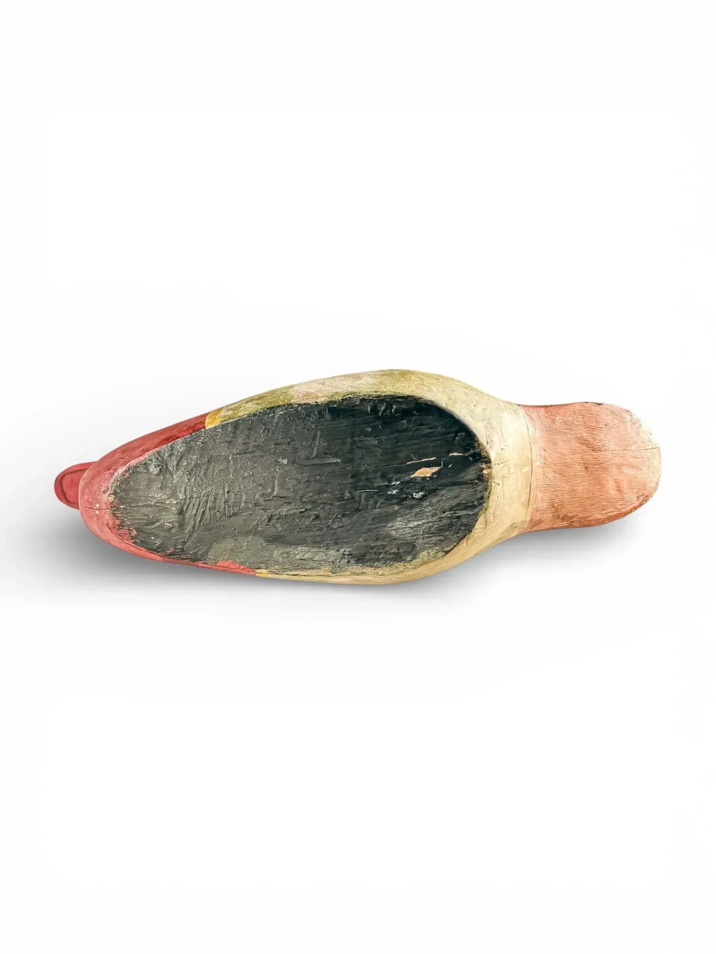 Bottom view of a hand-painted vintage ceramic shoe figurine on white background