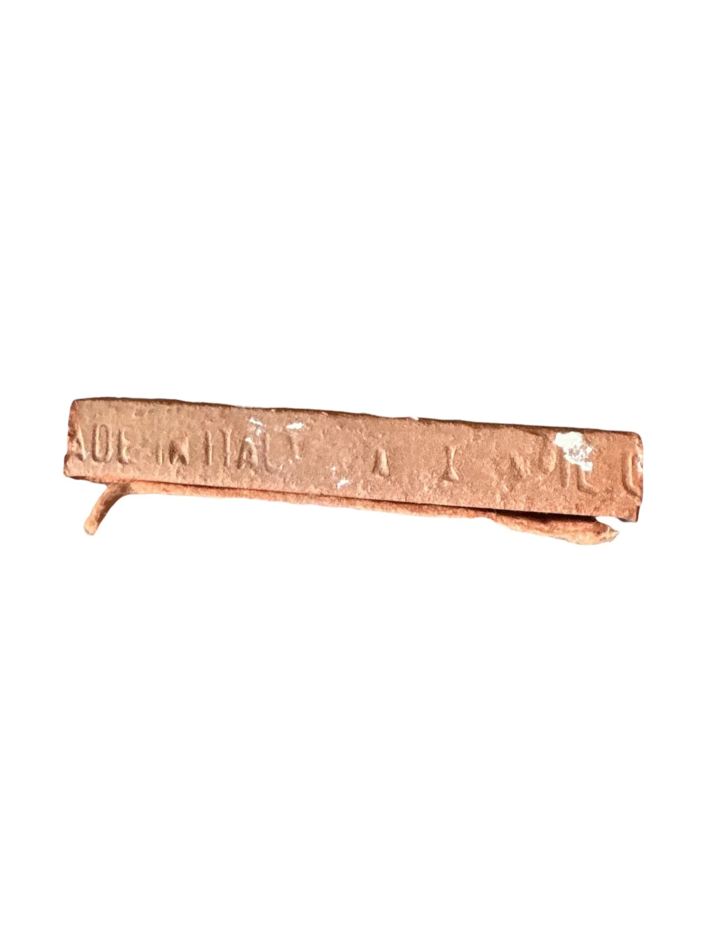 Rusty, bent metal bar with partially visible embossed text on white background