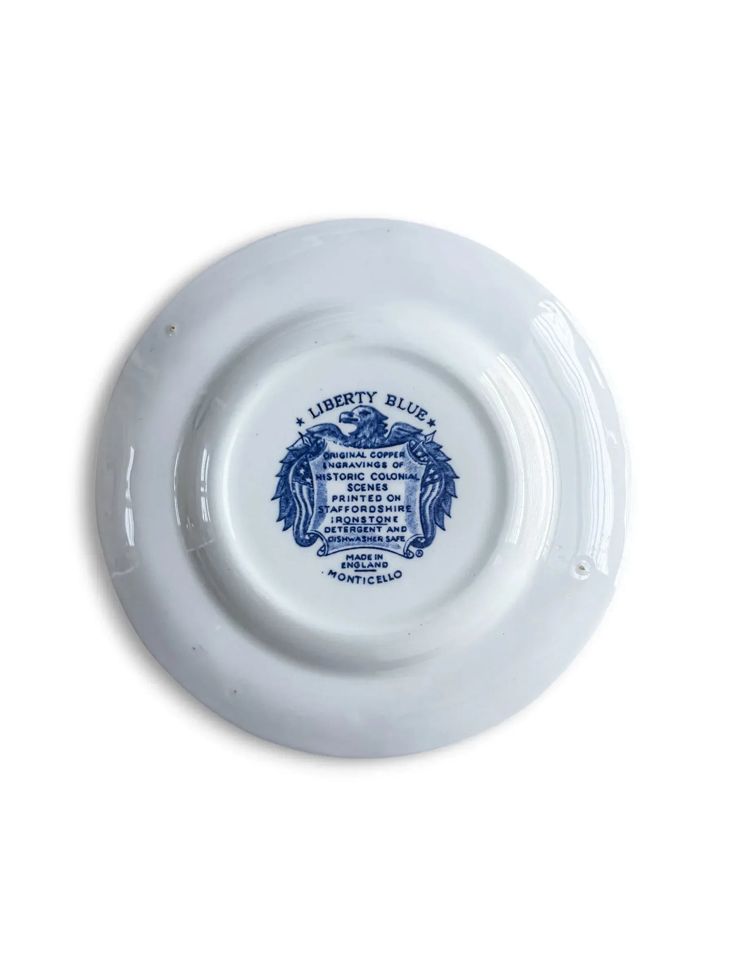 Reverse of the Liberty Blue Monticello bread plate with the original eagle-and-shield backstamp reading Liberty Blue, Staffordshire ironstone, Made in England, Monticello.