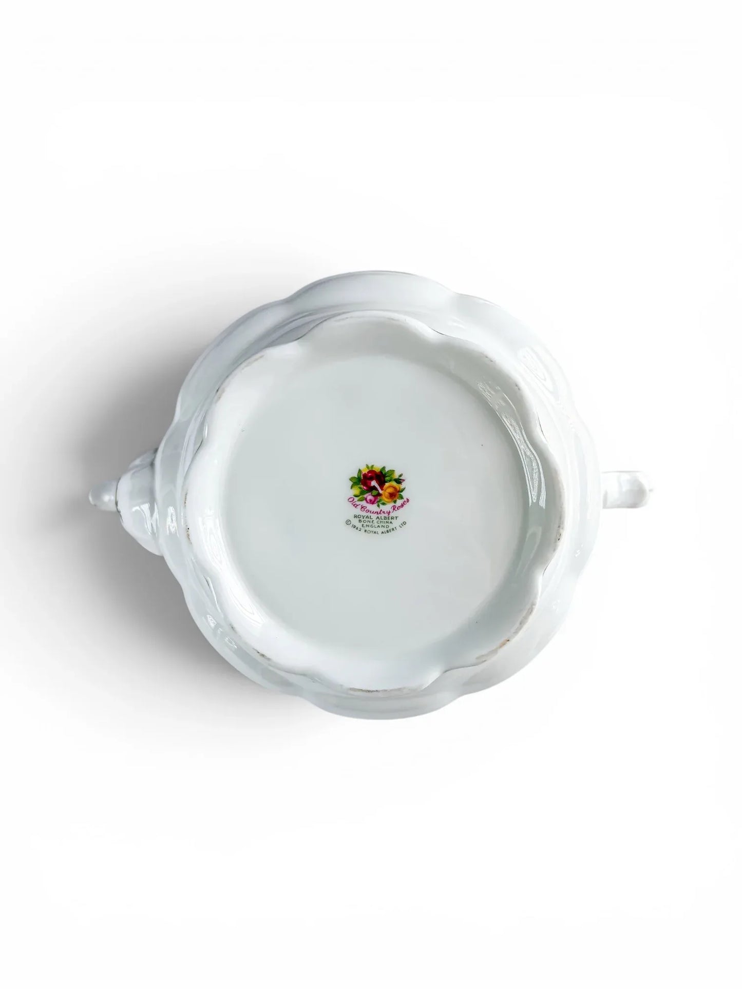 Close-up of the underside base of the teapot, showing the authentic multi-coloured floral factory backstamp certifying first-quality manufacture in England.