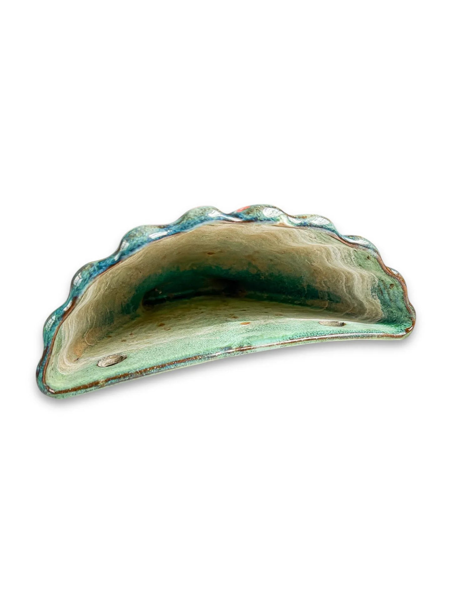 Green ceramic wall pocket planter with scalloped edge and rustic vintage glaze