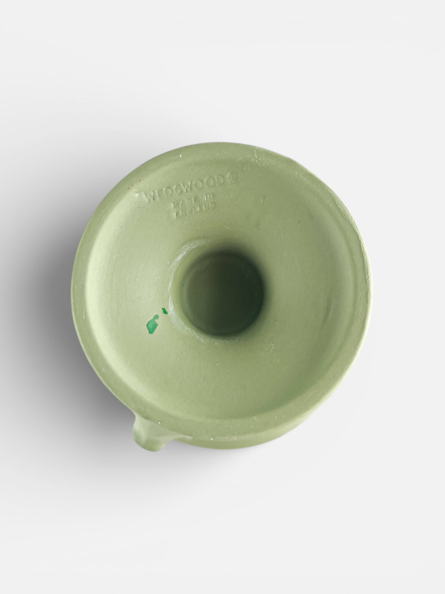 Top view of a green Wedgwood ceramic piece with embossed logo and central hollow opening