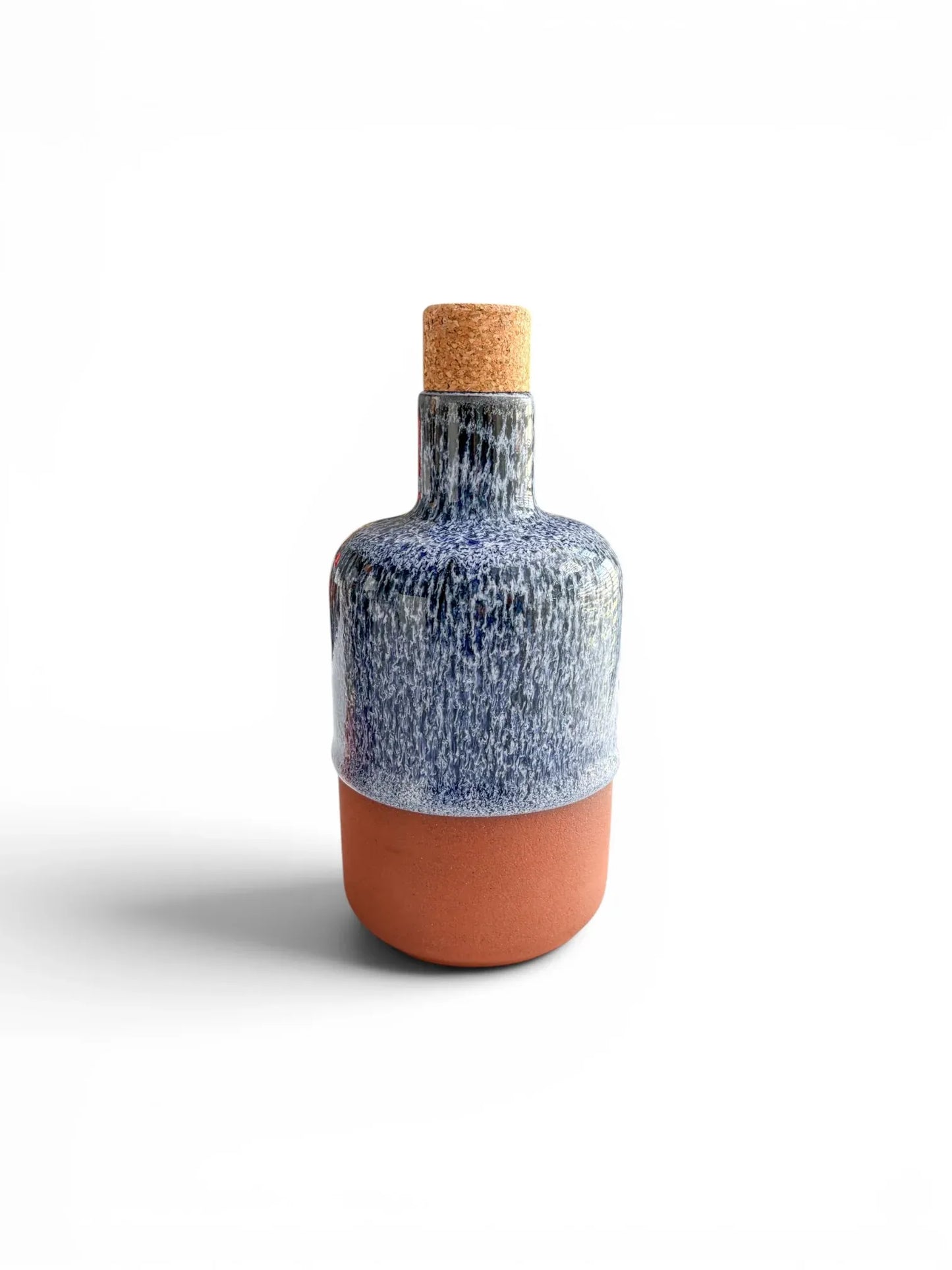 Front view of the Wiid Design olive oil bottle in cobalt blue reactive glaze. The high-gloss blue finish contrasts with the matte red earthenware base and a tapered natural cork stopper.
