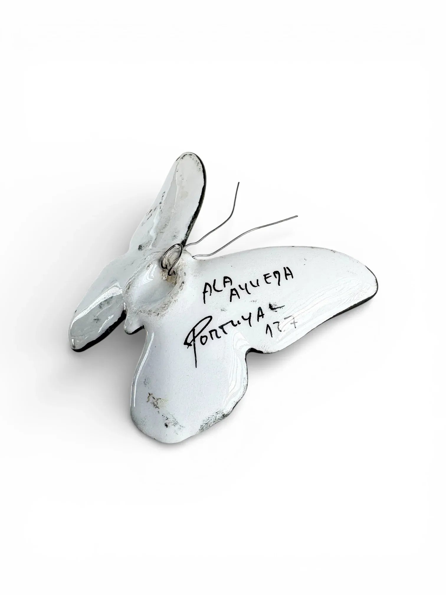 Vintage white porcelain butterfly figurine with handwritten markings, collectible tableware.