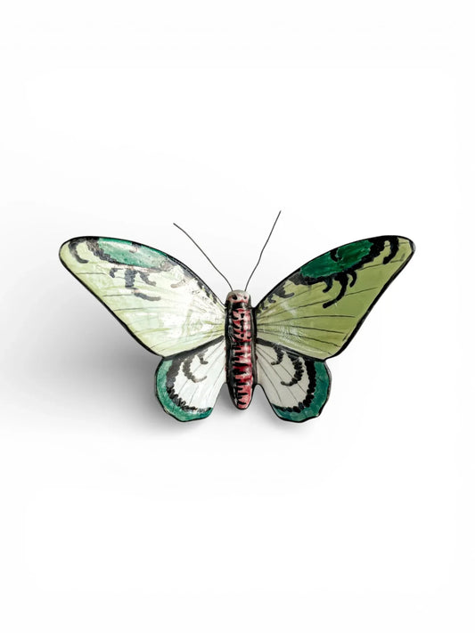 Hand-painted porcelain butterfly figurine with green and black wings on white background