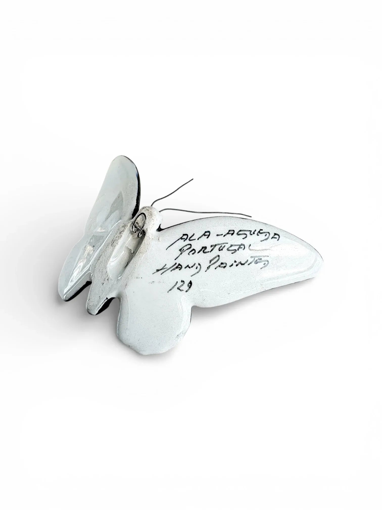 Hand-painted white porcelain butterfly figurine with wire antennae and script on wing