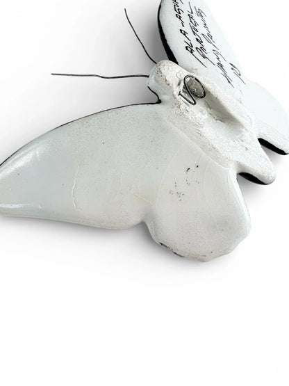 Vintage white ceramic butterfly wall decor with wire antennae on white background
