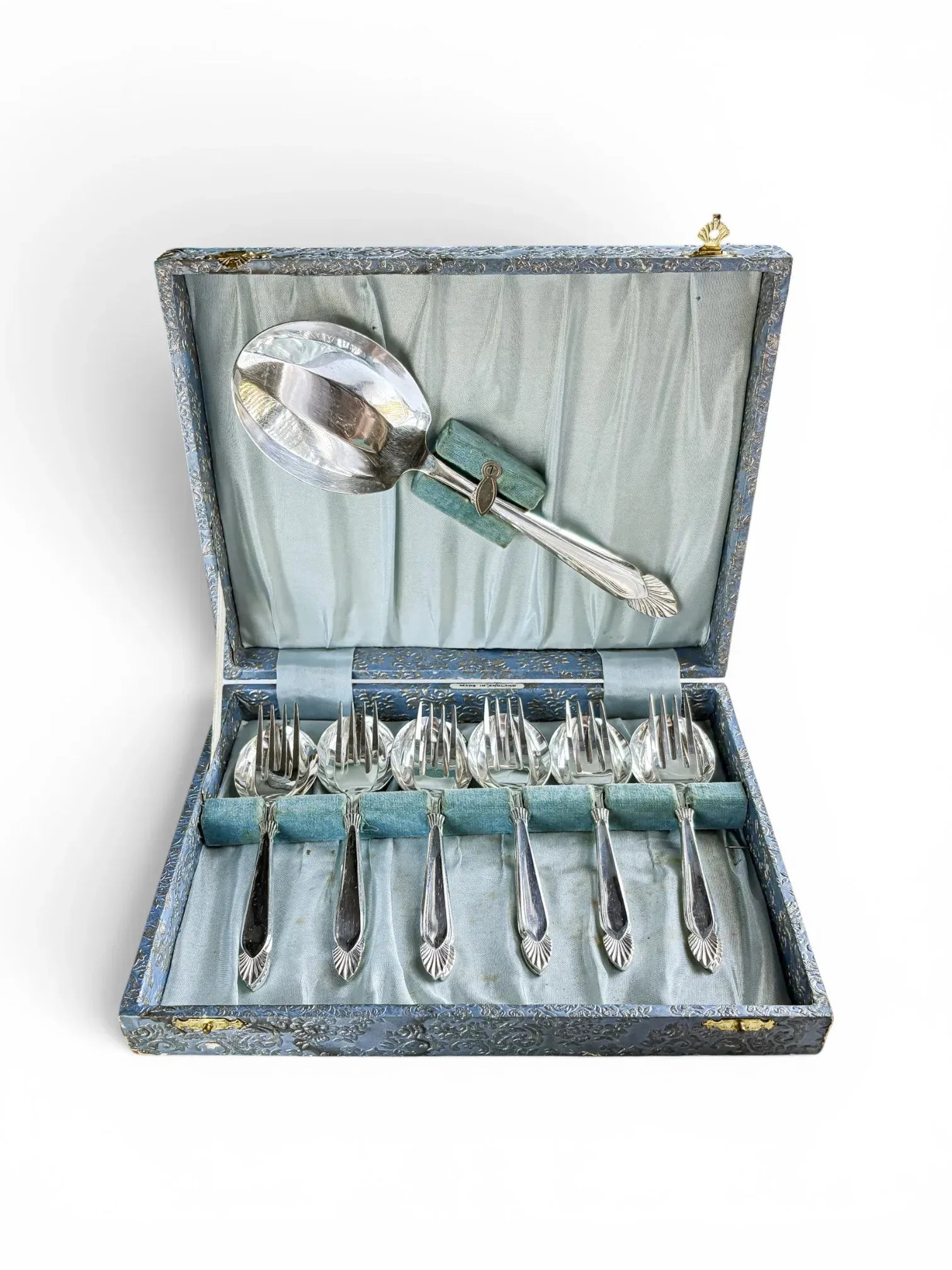 Complete 13-piece vintage Angora silver-plated dessert service presented in an open blue damask presentation box with a pale blue satin lining, showing a large serving spoon and six nested fork and spoon sets.