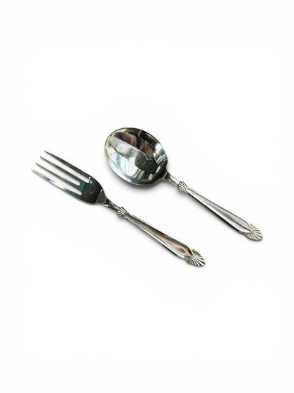 A matching pair of vintage silver-plated dessert fork and spoon by Angora, highlighting the polished mirror finish and Art Deco-inspired shell and fan motif on the handle finials.