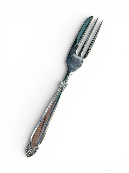 Vintage silver-plated serving fork with decorative handle on white background