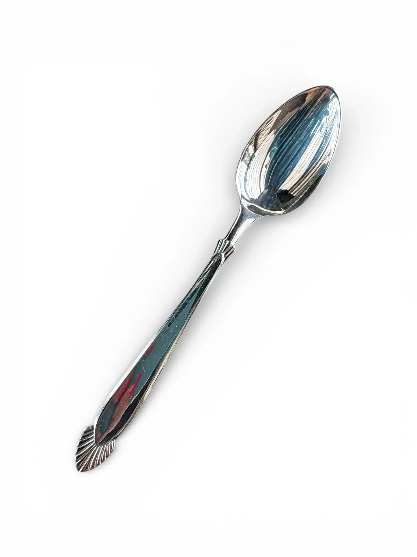 Vintage silver spoon with decorative handle on white background, tableware and serveware