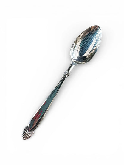 Vintage silver spoon with decorative handle on white background, tableware and serveware