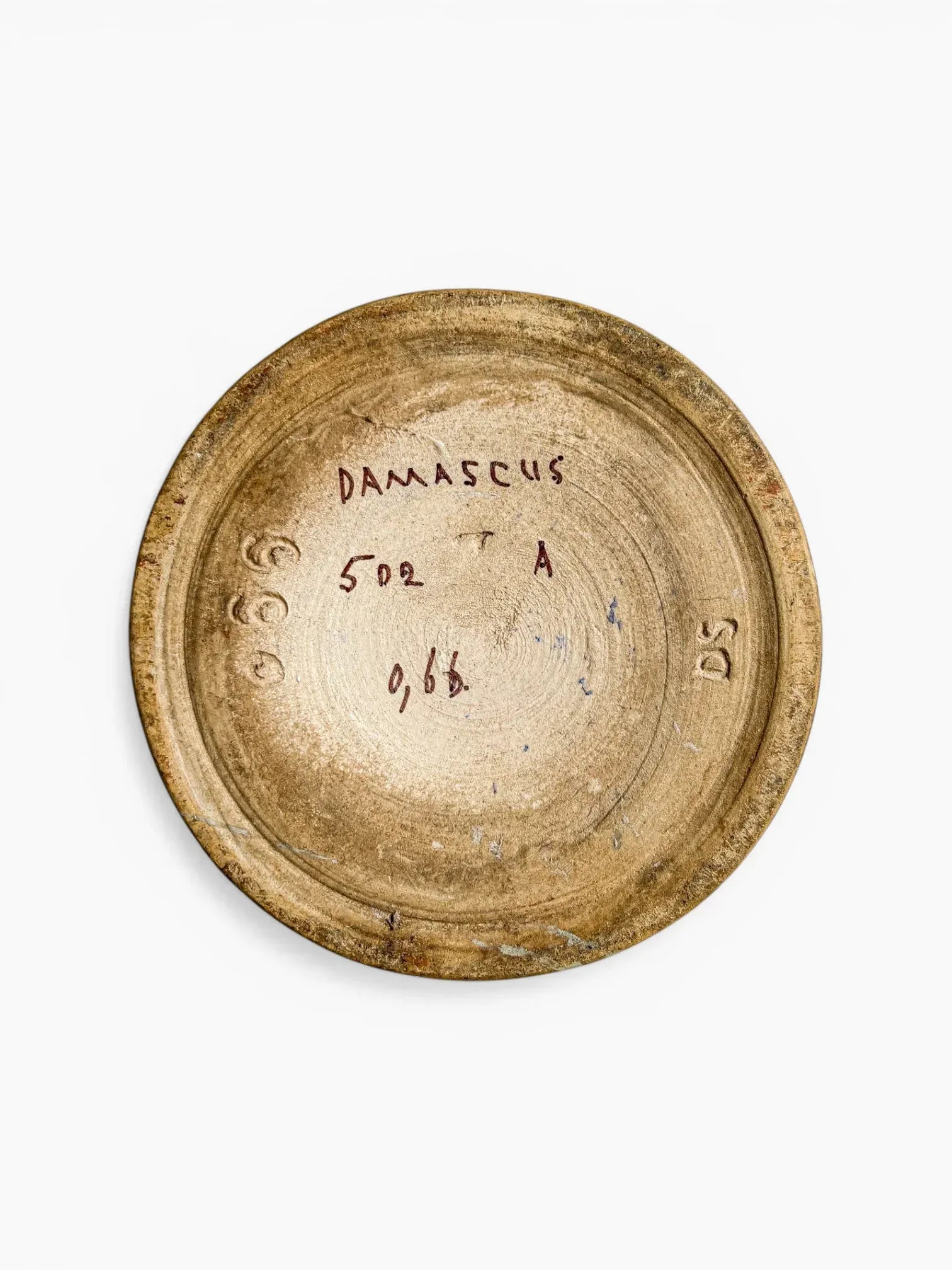 The underside of an antique Gouda Damascus vase showing verified hand-painted markings: 'DAMASCUS' decor name, shape number 502, artist initials 'DS,' and internal factory work numbers.