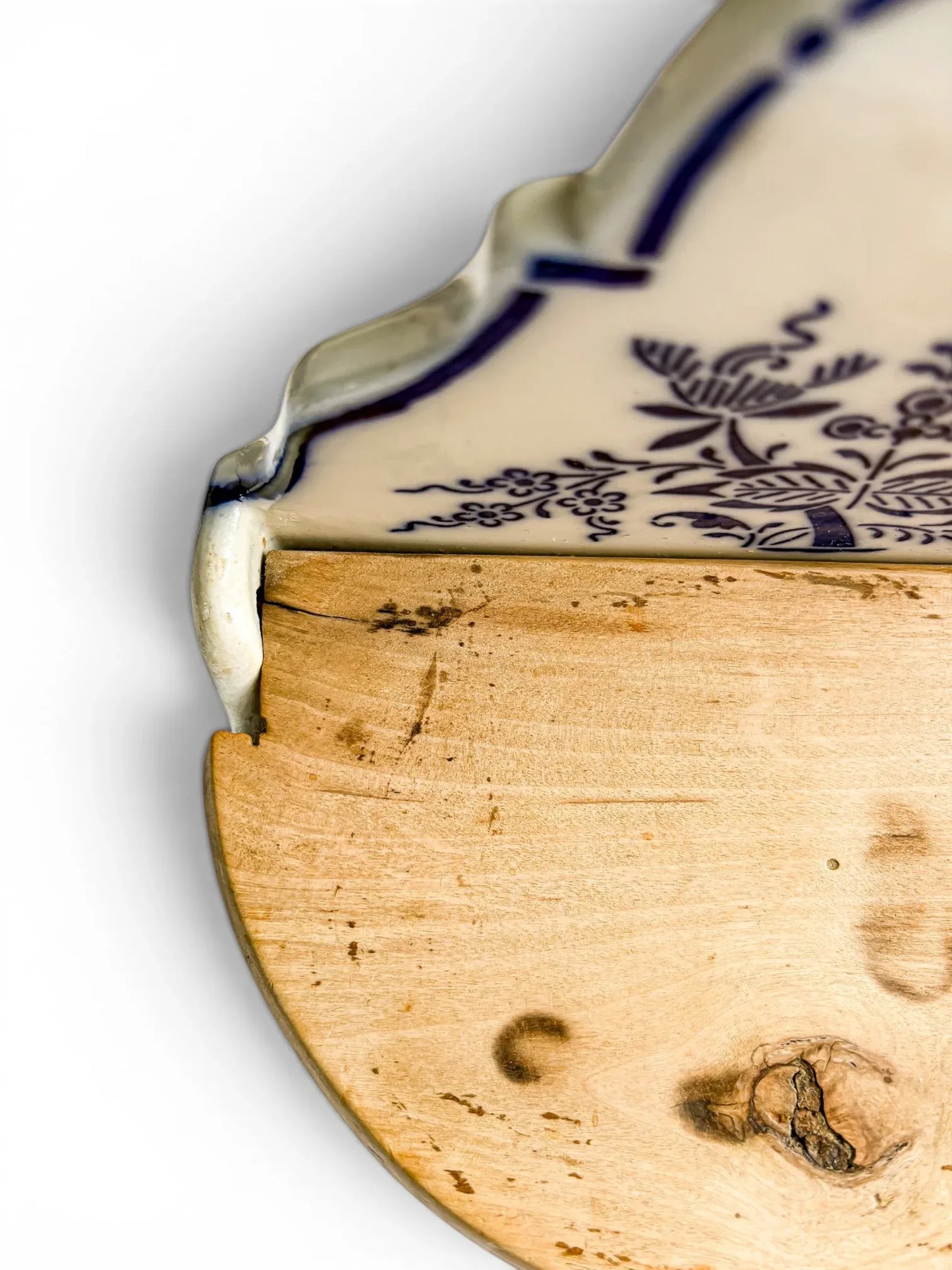 Close-up detail of the left wooden hinge area, showing the rustic wood grain, a minor stable hairline split near the pin, and the original hand-fitted hinge assembly.