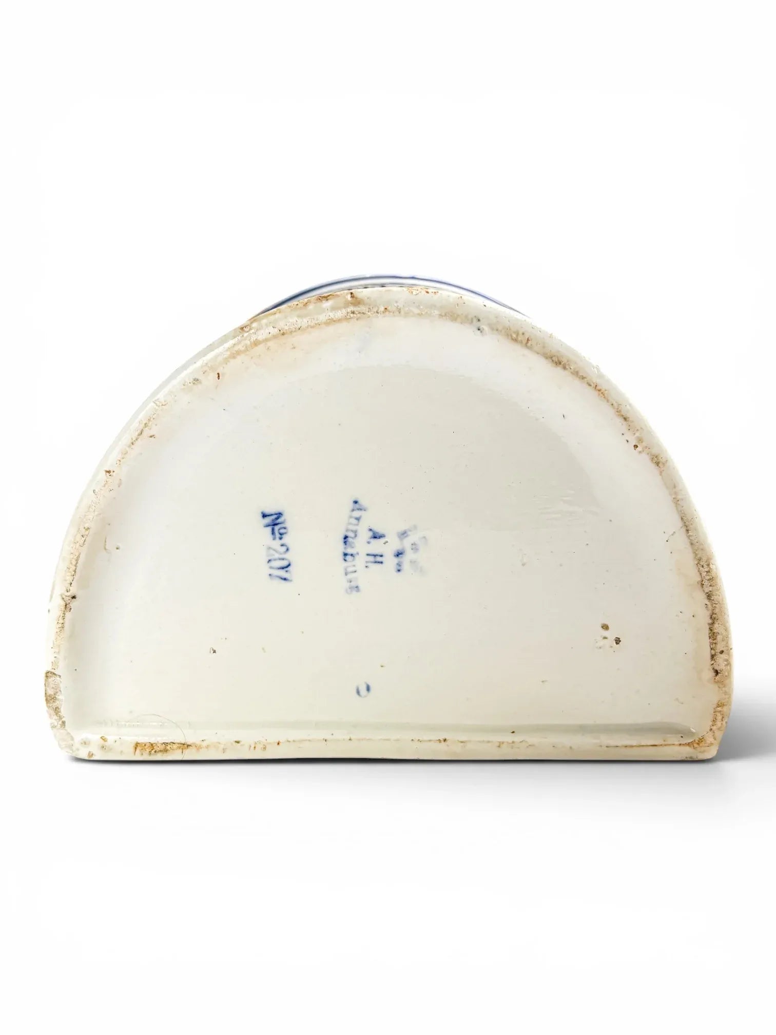 The flat, unglazed stoneware base of the antique German kitchen box, showing the blue underglaze A.H. Annaburg maker's mark and mold number No. 207 on a white background.