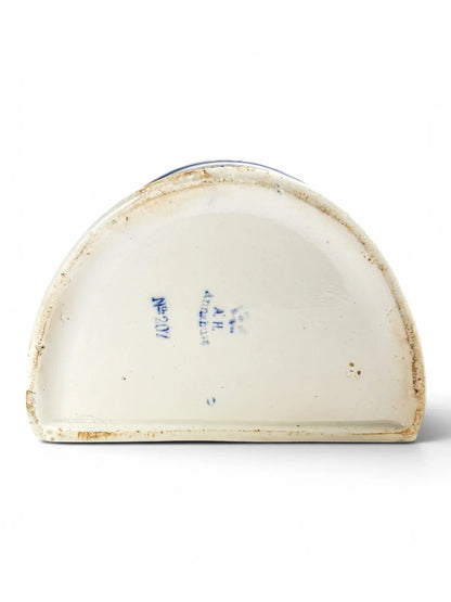 The flat, unglazed stoneware base of the antique German kitchen box, showing the blue underglaze A.H. Annaburg maker's mark and mold number No. 207 on a white background.