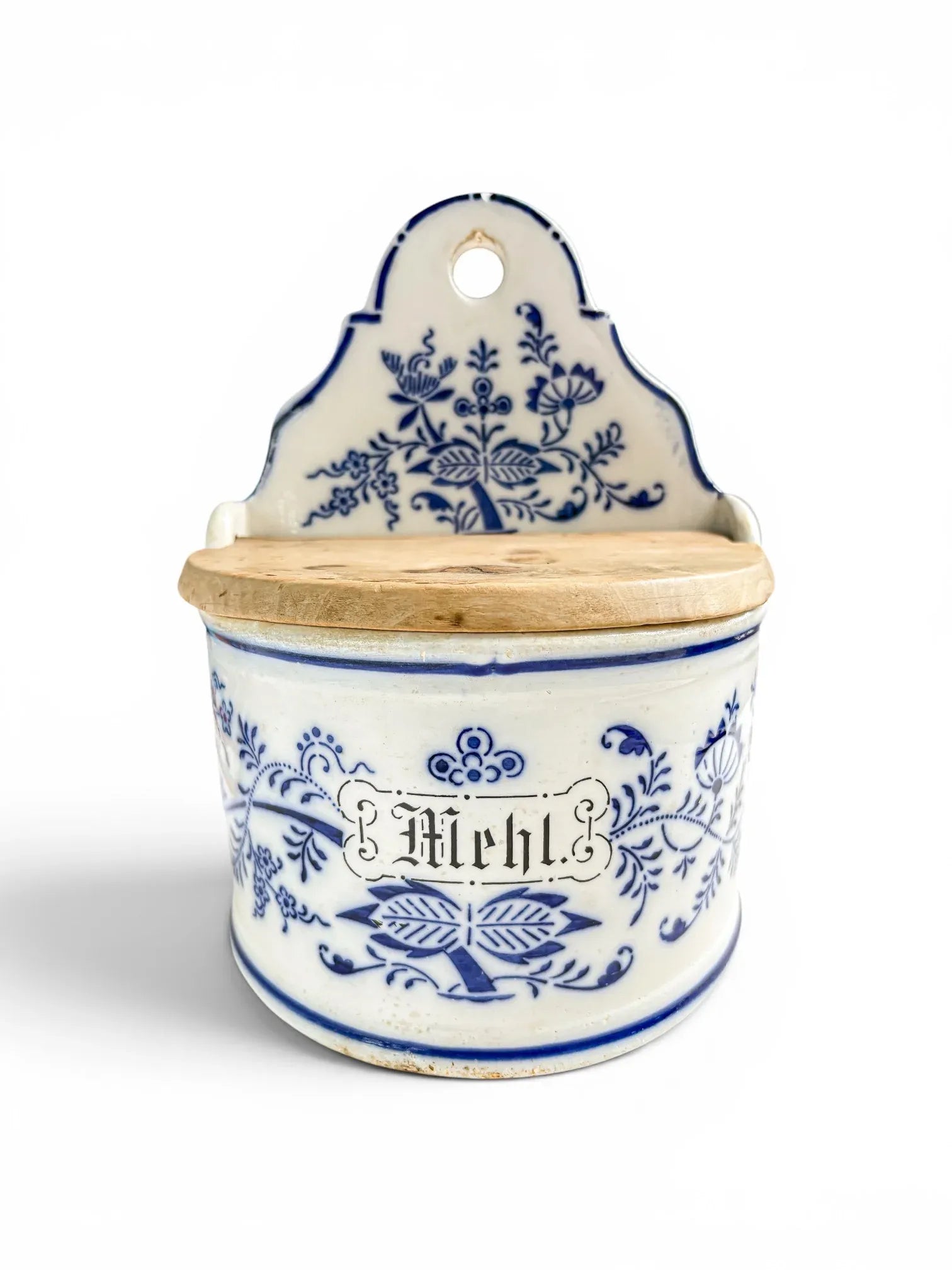 Close-up front view of an antique German ceramic flour box showing the word Mehl in Gothic script framed by cobalt blue floral transferware patterns.