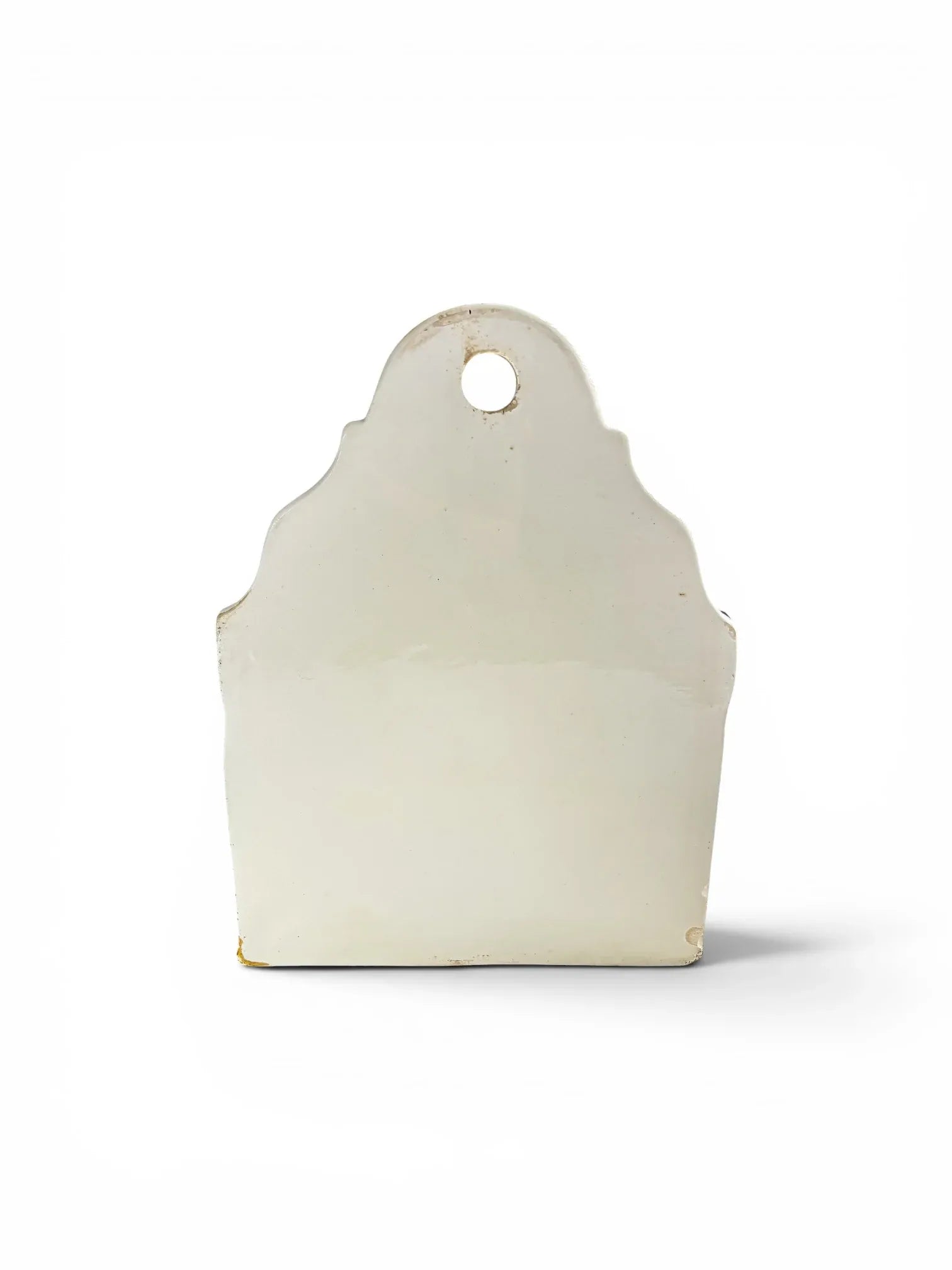 Flat back view of the antique German ceramic kitchen box, displaying the hanging eyelet at the top and a small, stable glaze chip on the bottom corner.