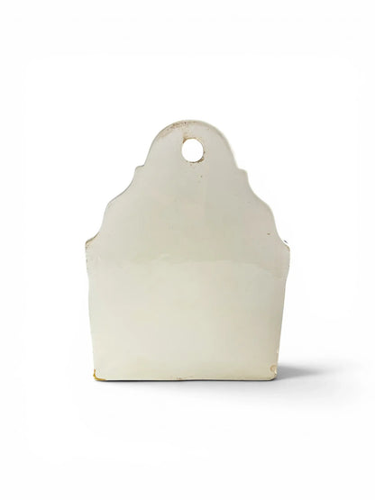 Flat back view of the antique German ceramic kitchen box, displaying the hanging eyelet at the top and a small, stable glaze chip on the bottom corner.