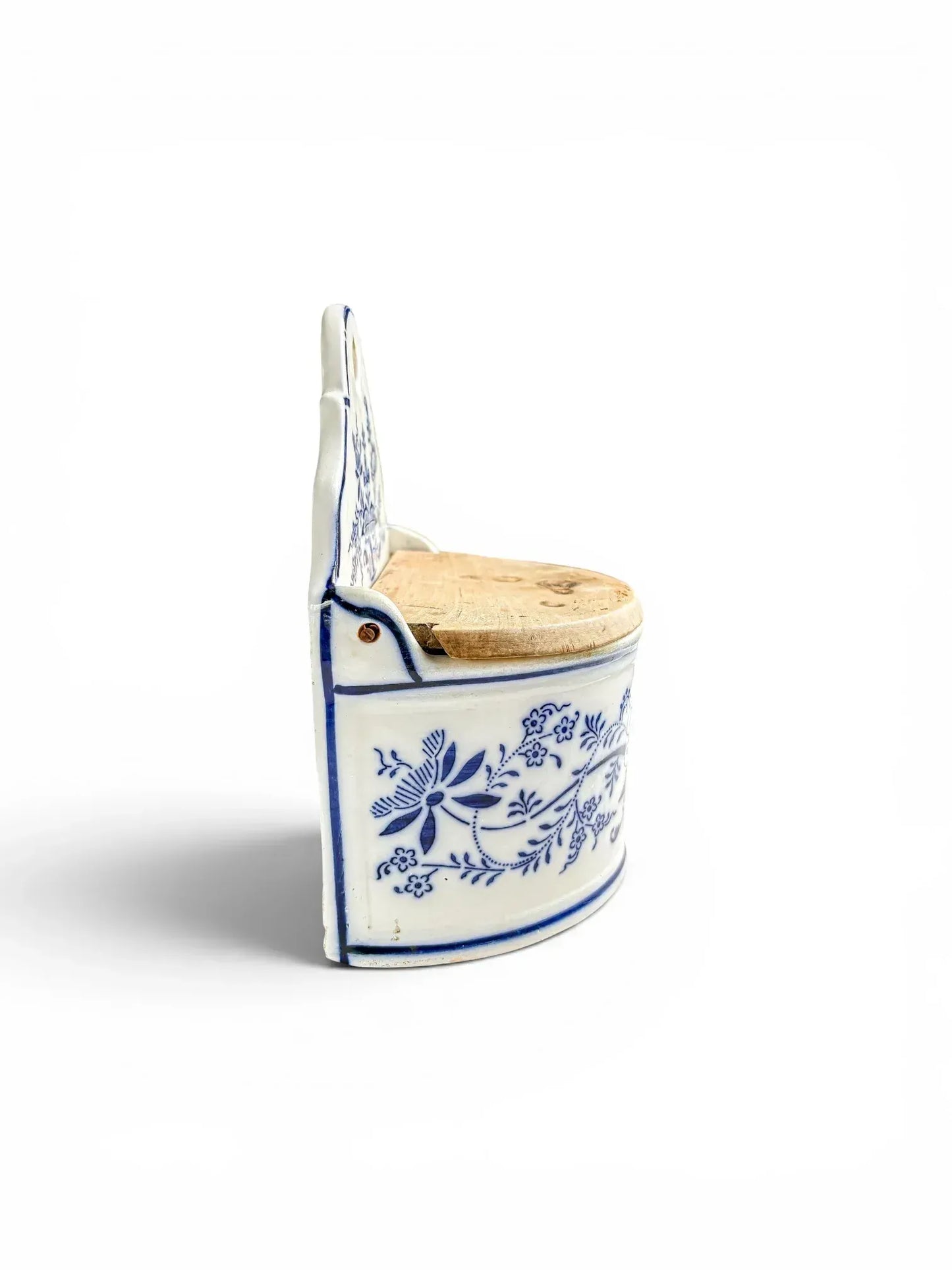 Left side profile of the antique German cobalt blue transferware storage box, highlighting the detailed floral design and the aged patina of the wooden lid.