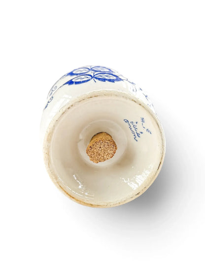 Base of an Arnart Blue Onion salt shaker with cork stopper and unglazed foot rim
