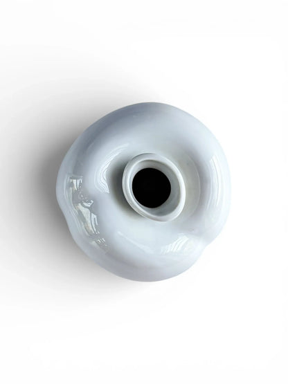 Top-down view of the Arzberg Peach vase highlighting the narrow offset aperture and the sculptural, lobed porcelain form.