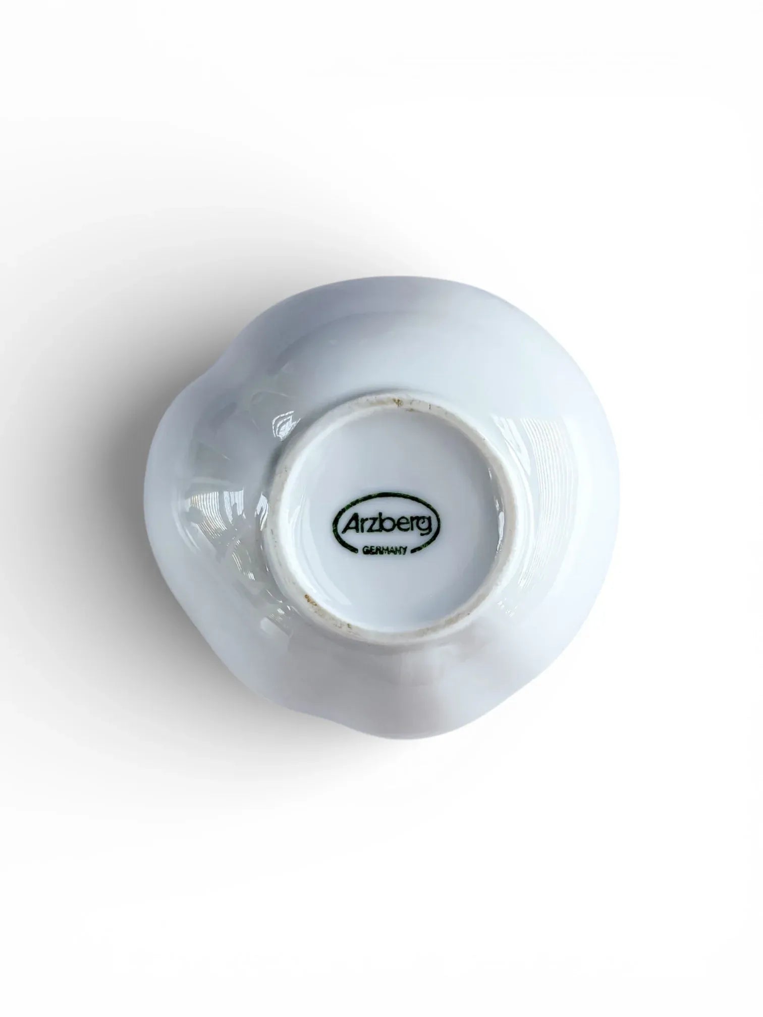 Underside of Arzberg porcelain vase featuring the authentic green oval "Arzberg Germany" manufacturer's stamp and unglazed foot ring.