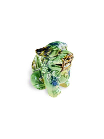 Small green ceramic Fu lion statue with intricate detailing and glossy finish on white background
