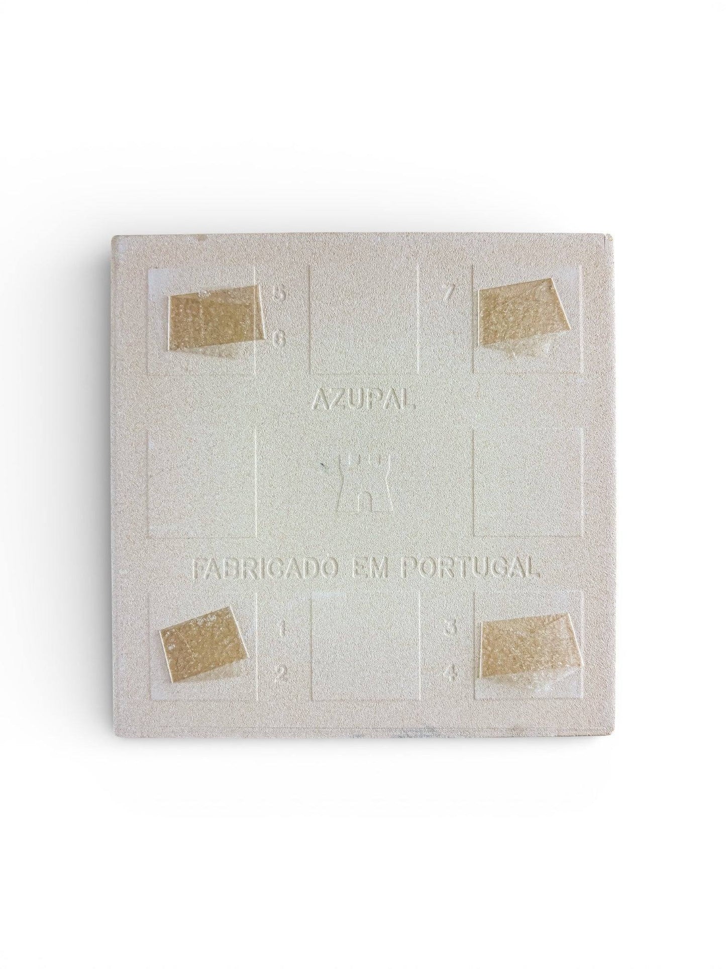 Underside of a vintage ceramic tile showing the authentic Azupal castle hallmark and Fabricado em Portugal stamp.