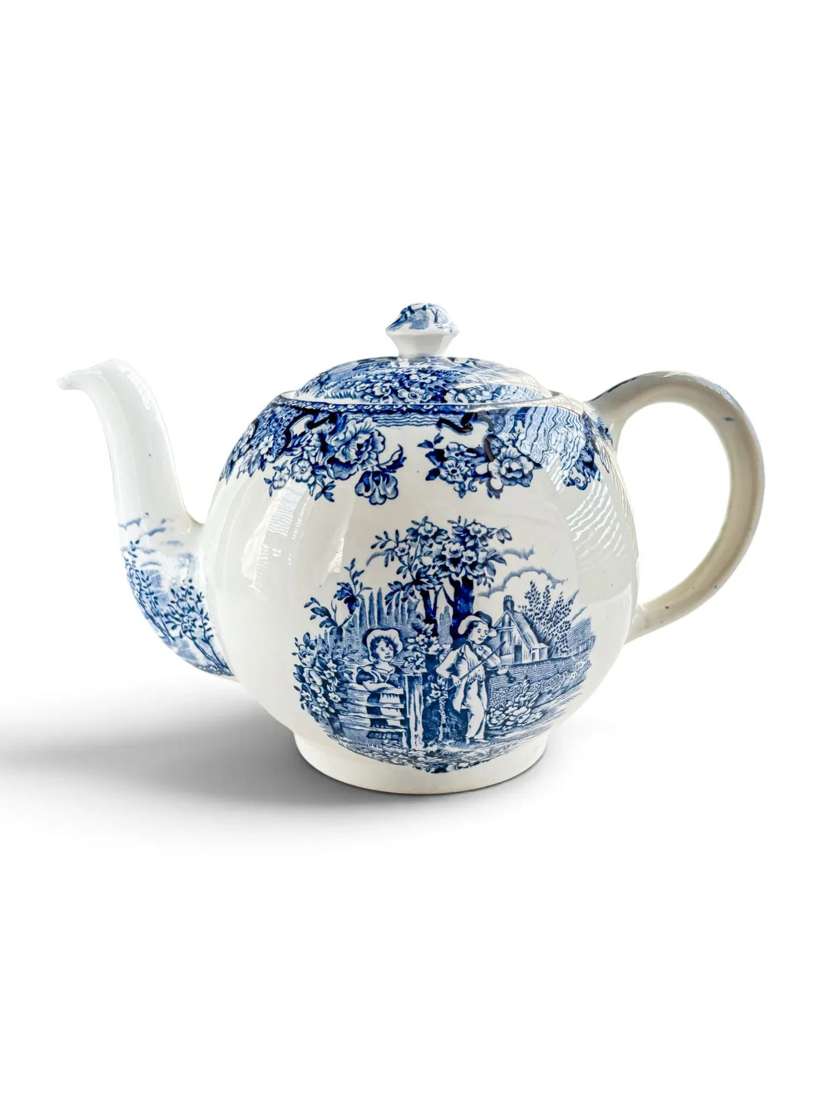 Vintage Barratts of Staffordshire Playtime teapot in blue and white transferware, shown from the front with spout to the left and handle to the right, pastoral scene of children at a fence.