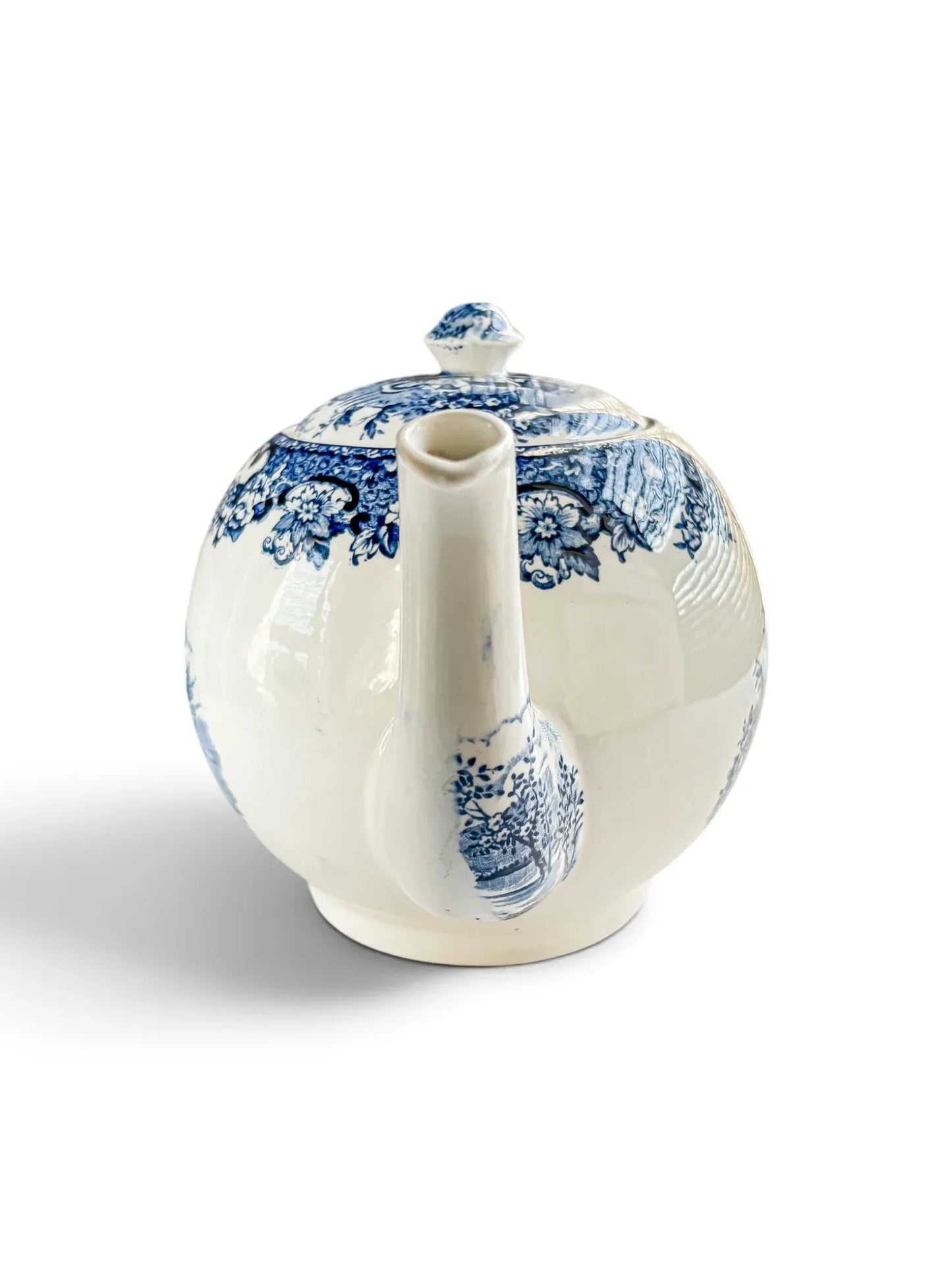 Side view of the Playtime teapot facing the spout, showing the floral shoulder border and the transfer on the spout.