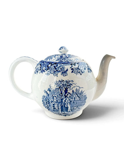 Reverse three-quarter view of the Barratts Playtime teapot with handle to the left and spout to the right.