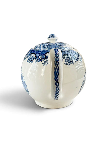 Rear view of the teapot showing the loop handle with blue wheat-sprig decoration.