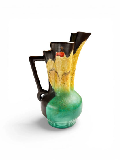 Side profile of a 1930s Beswick pottery jug showing the sharp architectural lines of the spout and the vibrant satin-matt Sunrise glaze finish.