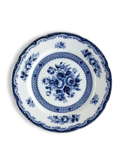 Blue and white porcelain plate with floral pattern and ornate border on white background