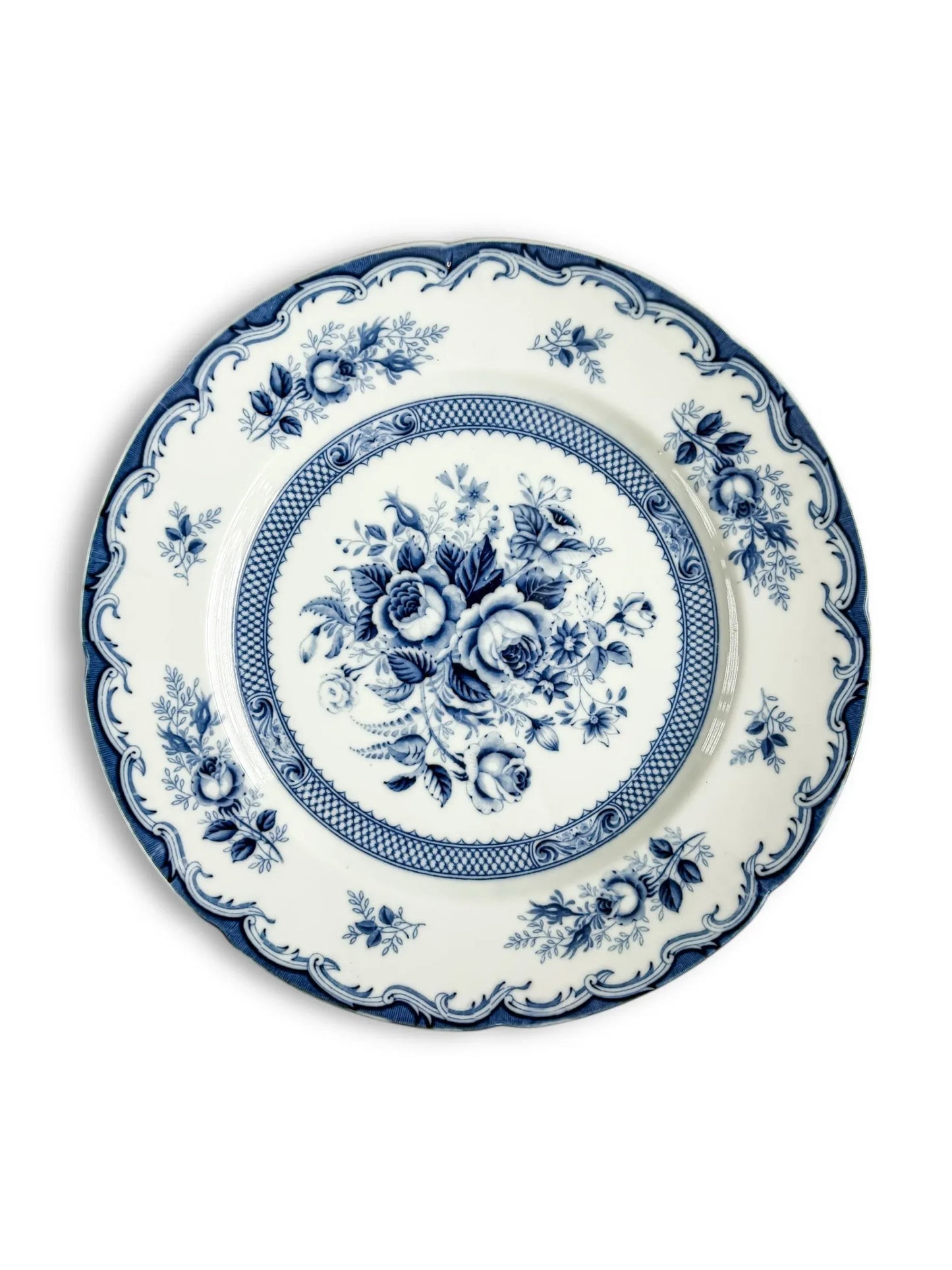 Blue and white floral porcelain plate with vintage decorative border on a white background