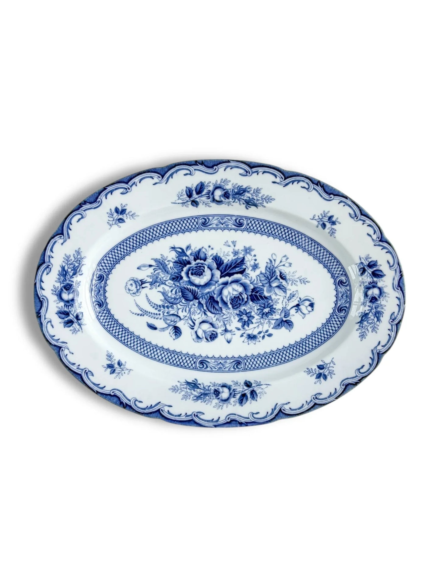 Blue and white oval porcelain platter with floral pattern and decorative border