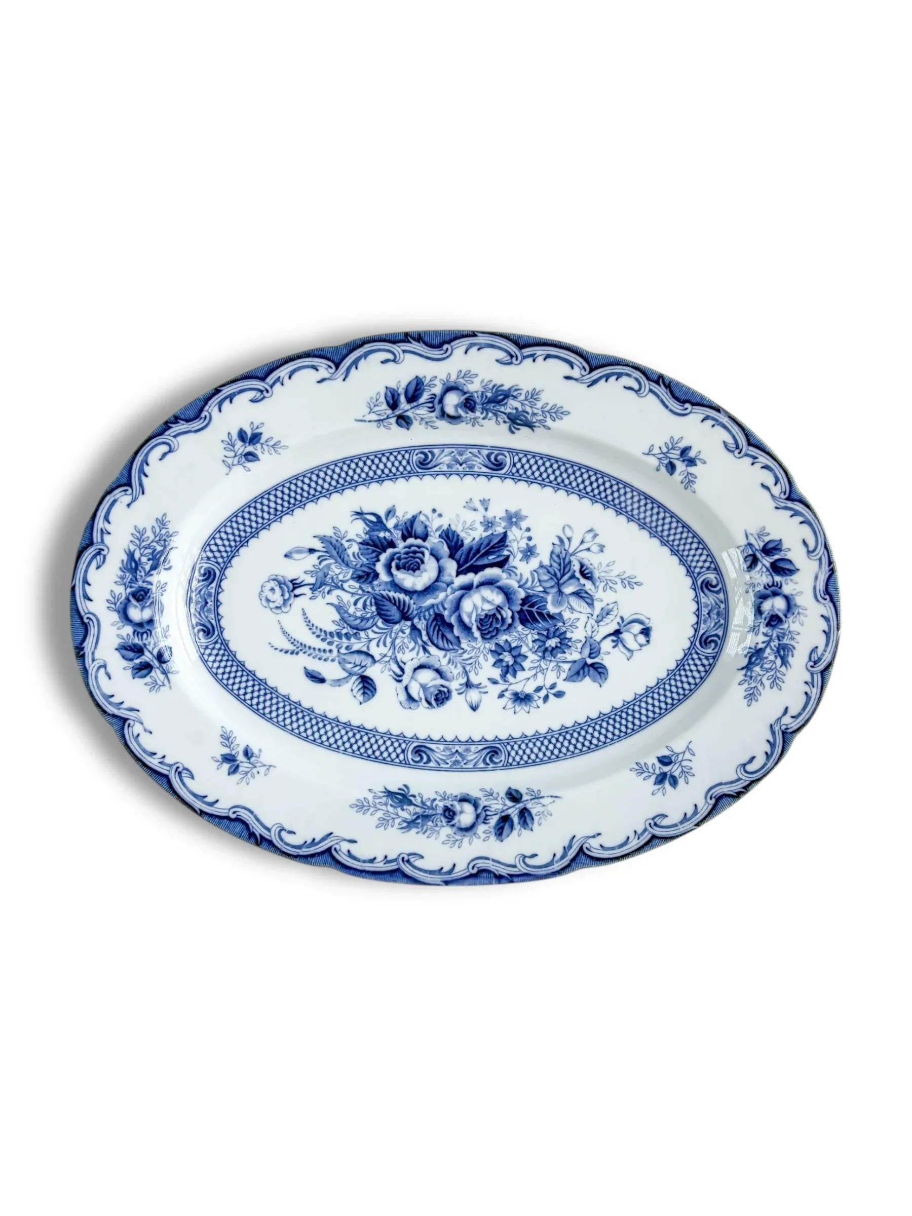 Blue and white oval porcelain platter with floral pattern and decorative border