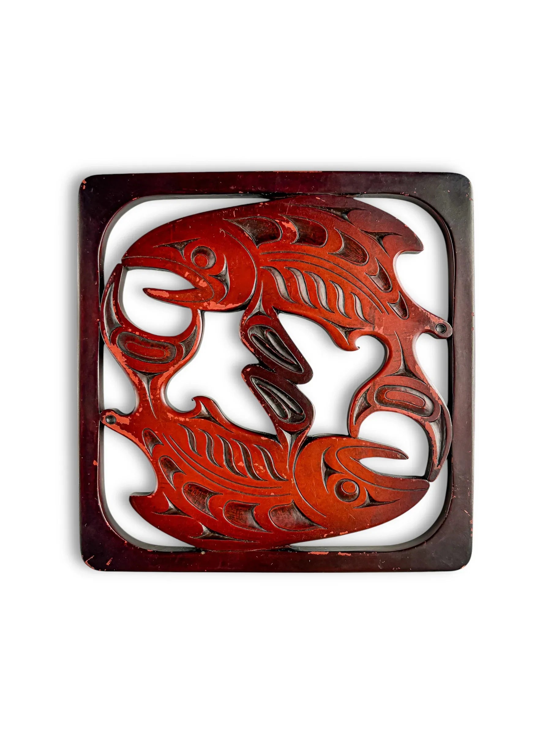 Vintage carved wood trivet with two stylized fish in a square frame, collectible tableware