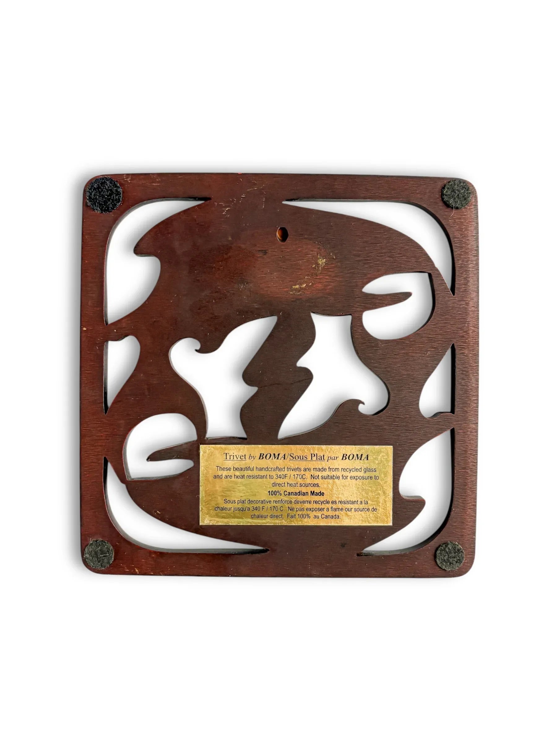 Handcrafted wooden trivet with cutout design and brass label, vintage home decor accessory