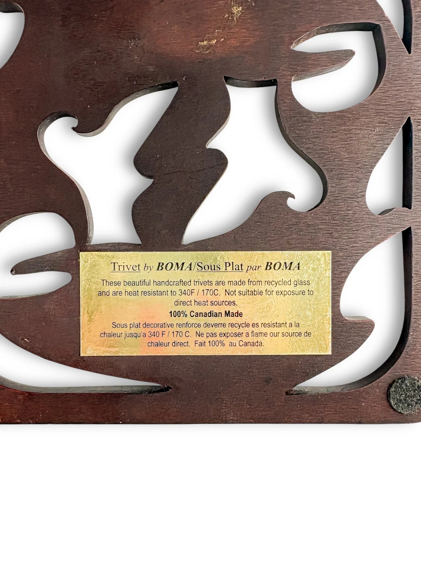 Handcrafted wooden trivet with cut-out leaf design and gold product label, vintage tableware.