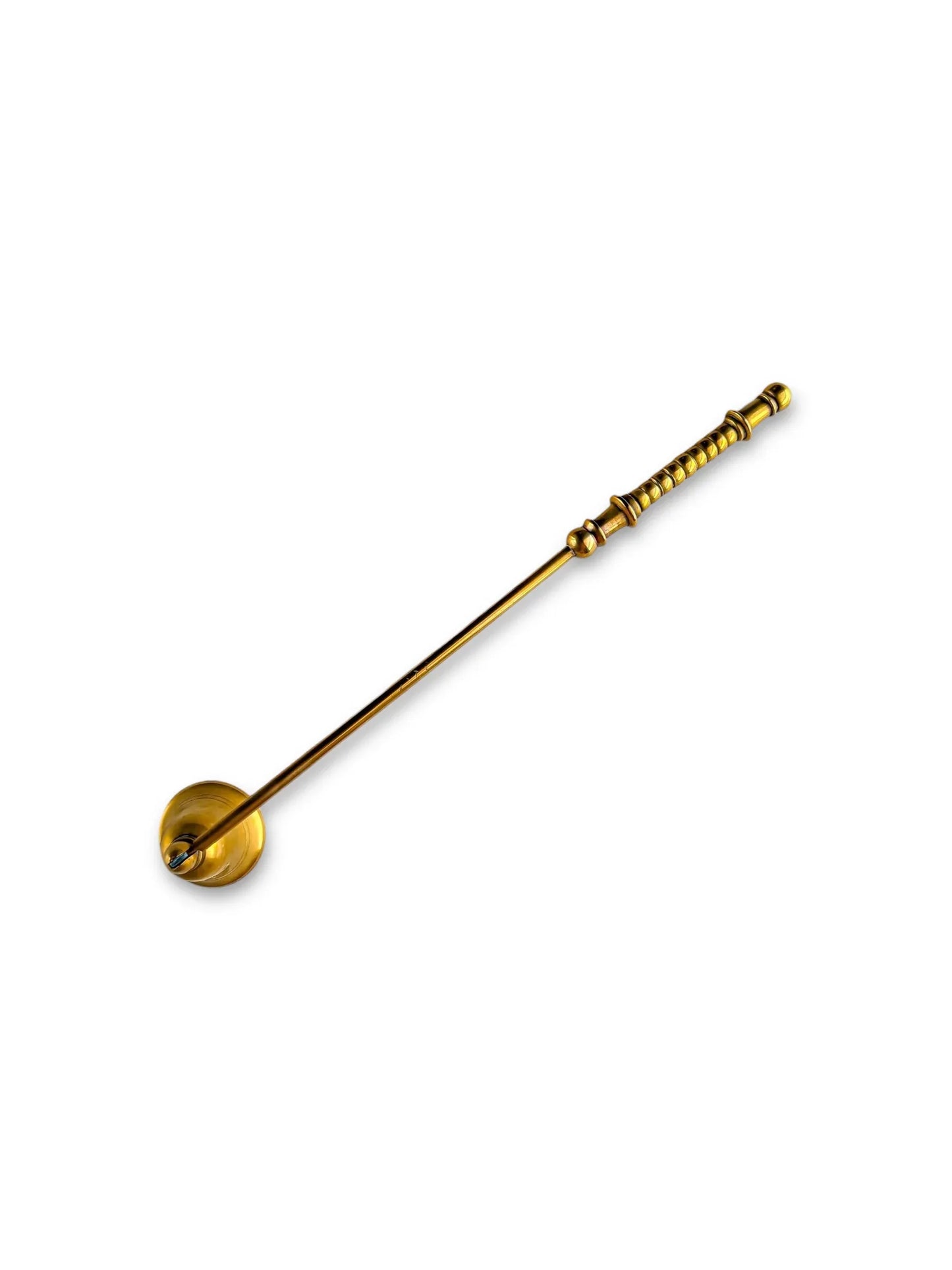 Vintage brass honey dipper with long detailed handle on white background