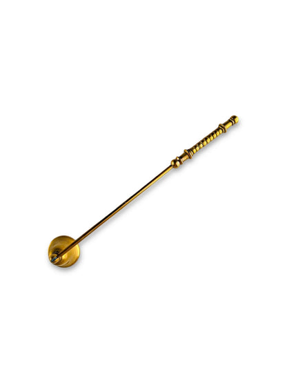 Vintage brass honey dipper with long detailed handle on white background