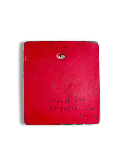 Back of a red square porcelain plaque with handwritten text 'Copy of icon Bulgaria 14th century'.