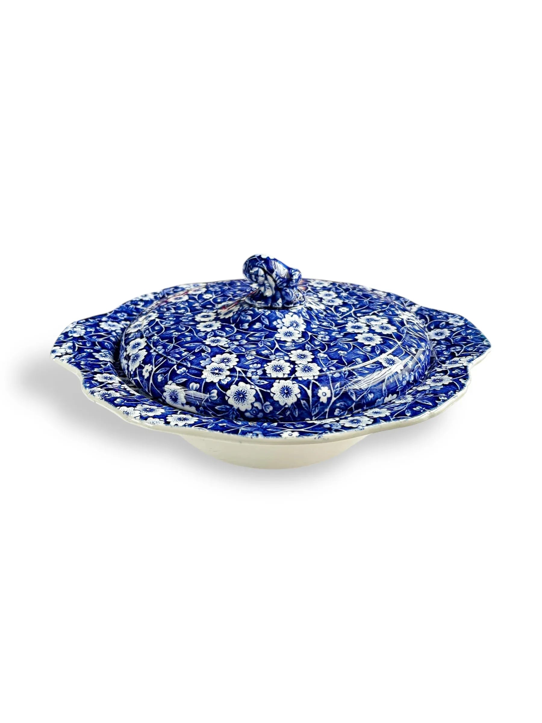 Blue and white floral patterned ceramic covered dish with scalloped edges