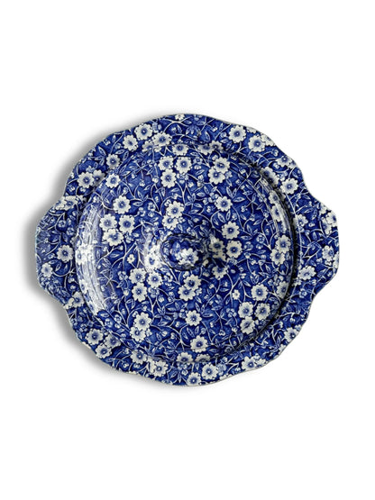 Blue and white ceramic covered dish with floral pattern and scalloped edges