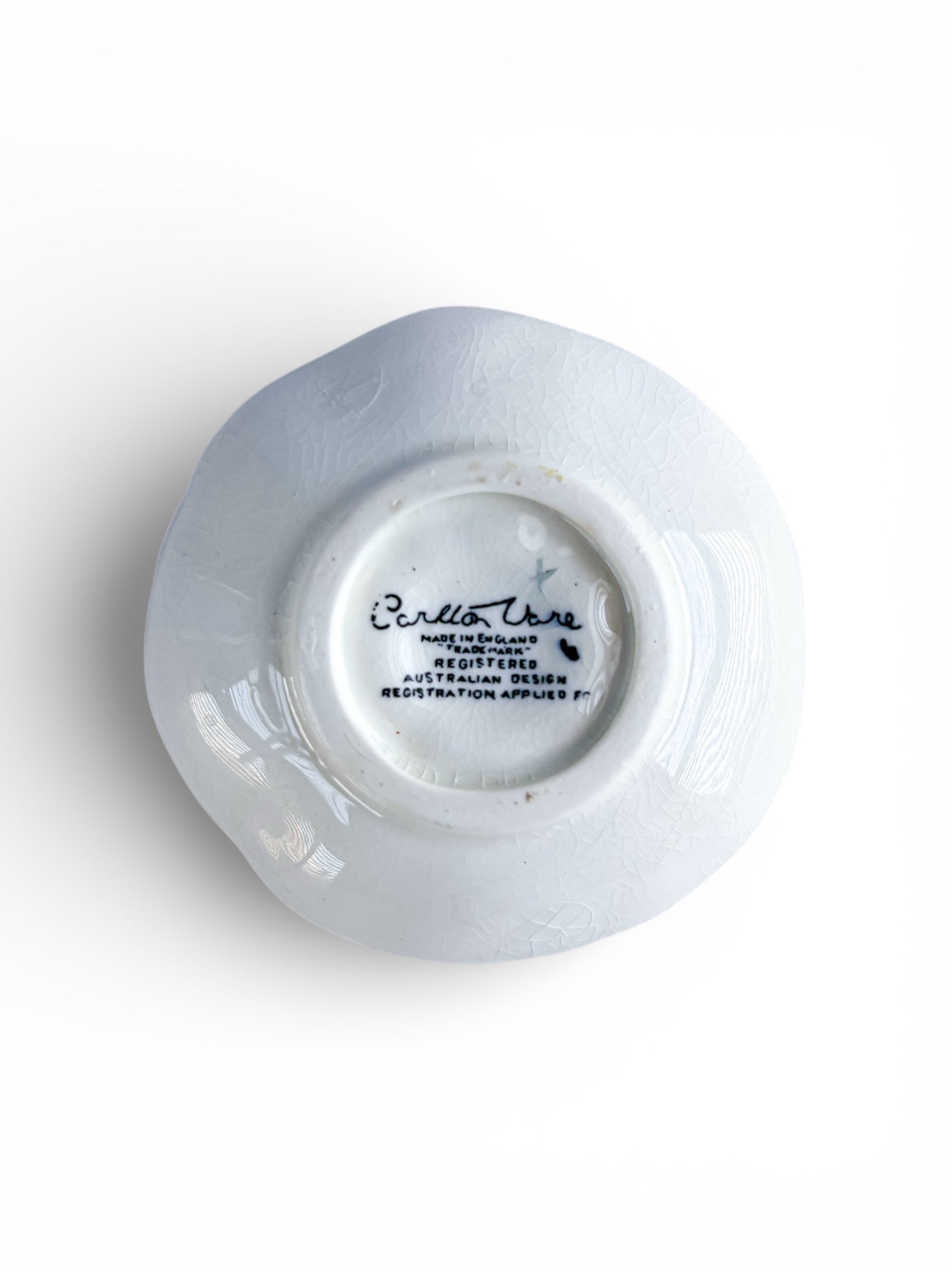 Bottom view of a white porcelain plate with Carlton Ware English mark and Australian design registration