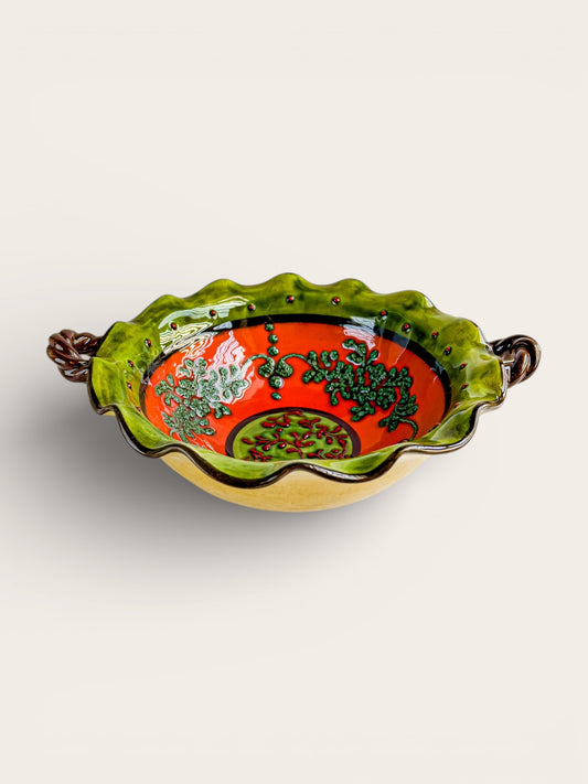 Vintage hand-painted ceramic serving bowl with green scalloped rim and red floral design, two handles
